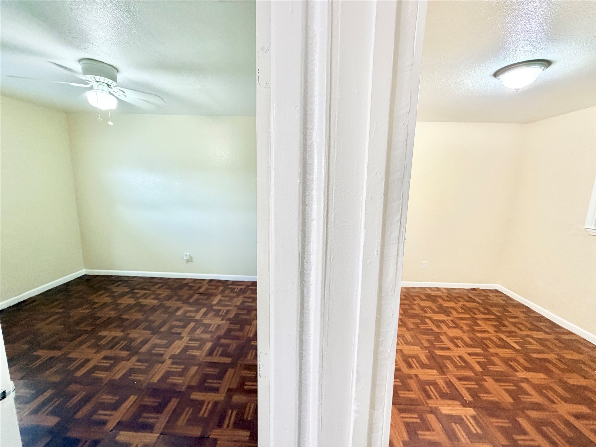 6257 Manor Road, Unit B Austin, TX 78723 - Photo 31 of 38 Two distinct rooms featuring patterned wood-finish flooring, light-colored walls, and overhead lighting fixtures