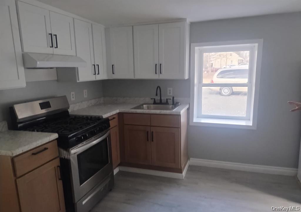 77 Randall Street, Unit B Florida, NY 10921 - Photo 3 of 3 a kitchen with granite countertop white cabinets appliances and a window