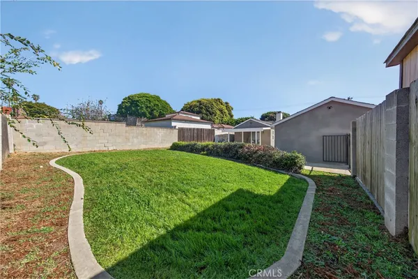 a view of a house with a yard and plants