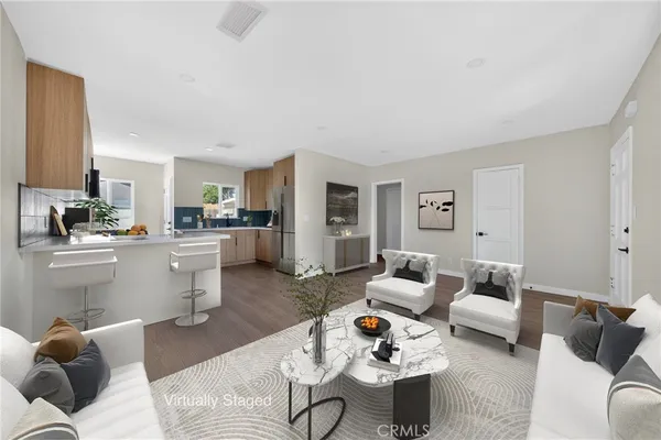 a living room with furniture and wooden floor