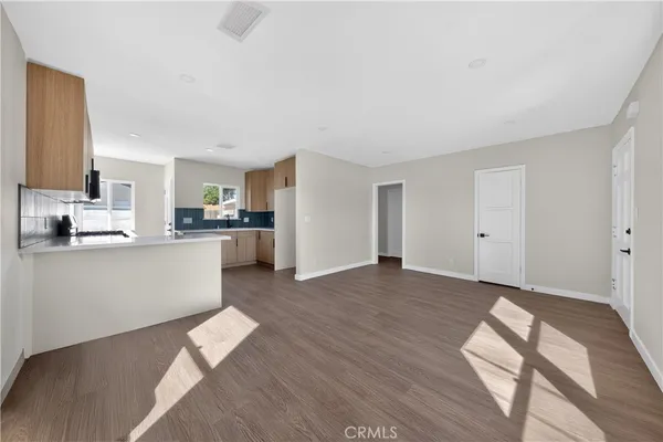 a view of kitchen with wooden floor and electronic appliances