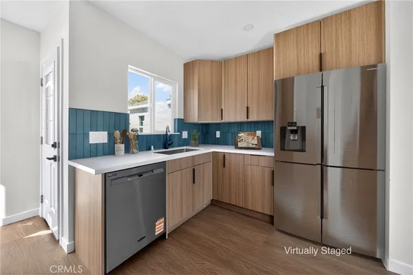 a kitchen with a refrigerator sink and cabinets
