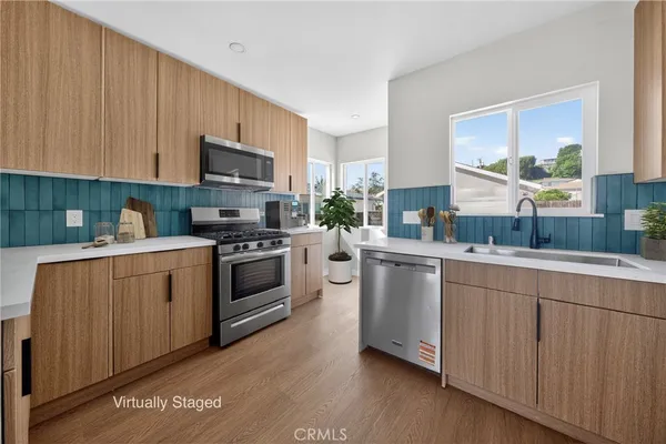 a kitchen with sink a microwave and cabinets