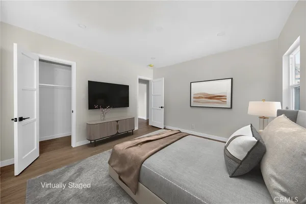 a bedroom with a bed and a flat screen tv