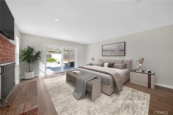 a spacious bedroom with a bed and a flat screen tv