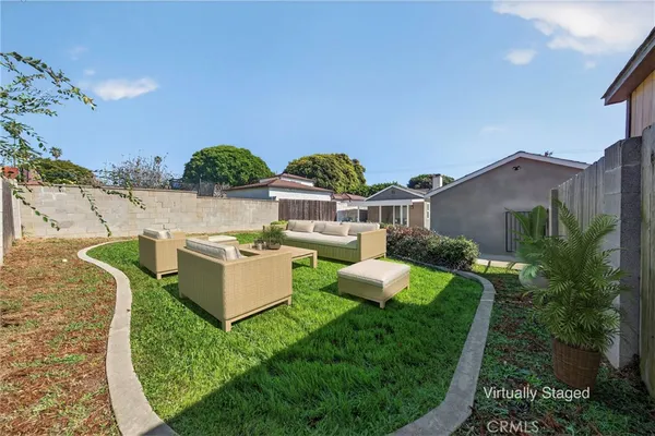 an aerial view of a house with yard and furniture