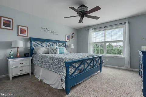 a spacious bedroom with a bed and a window