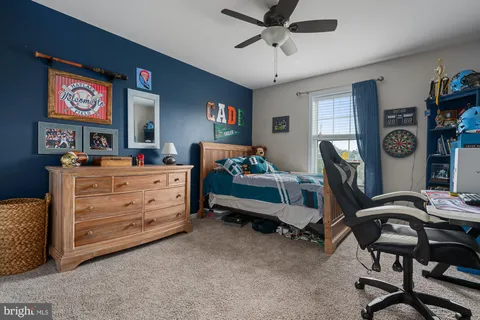 a bedroom with furniture and a window