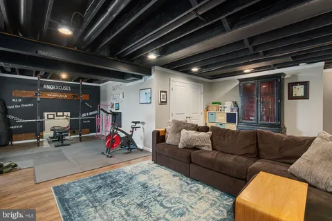 a living room with furniture a red table and chairs