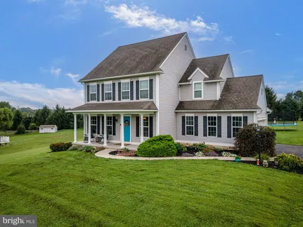 a front view of a house with a yard table and chairs