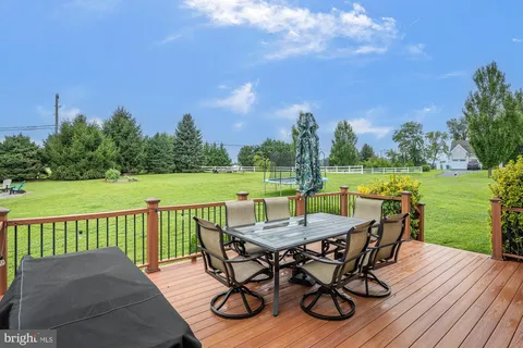 a view of a chair and table on the garden