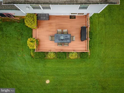 a view of a house with a big yard and a large tree