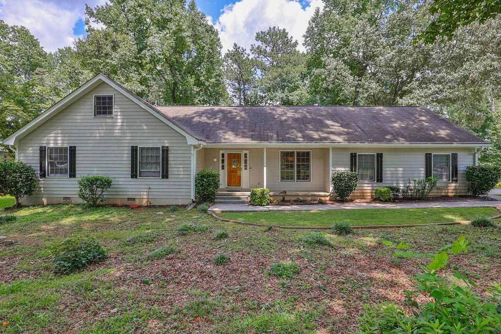 a front view of a house with a garden and porch