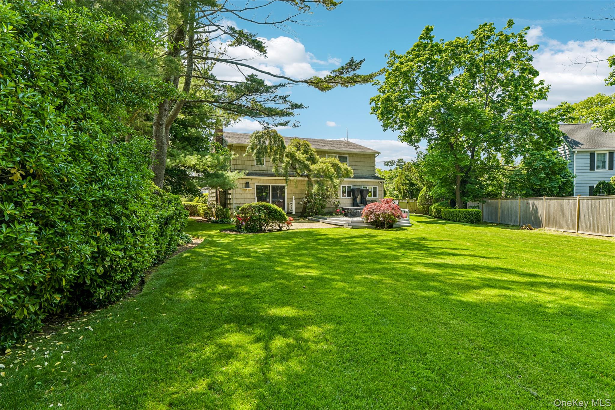 100 Hewlett Neck Road Woodmere, NY 11598 - Photo 36 of 45 a view of a house with a big yard