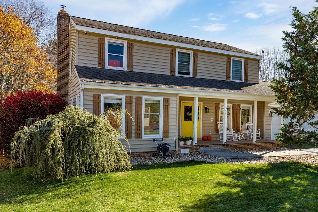 a front view of house with yard and outdoor seating