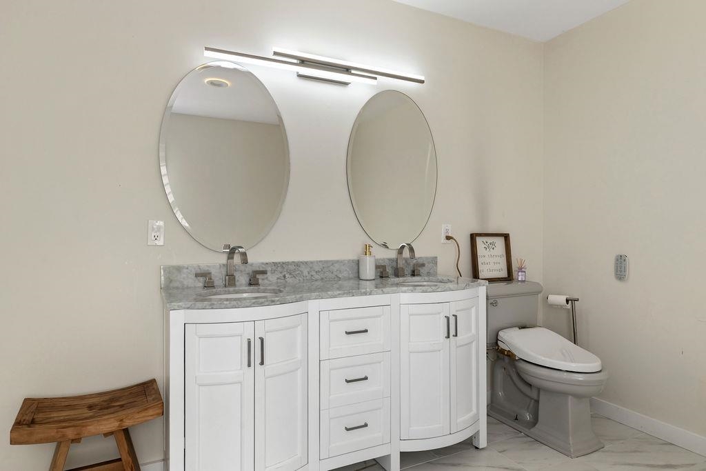 1368 Bluewater Road Harrisonburg, VA 22801 - Photo 22 of 52 a bathroom with a granite countertop toilet a sink and a mirror