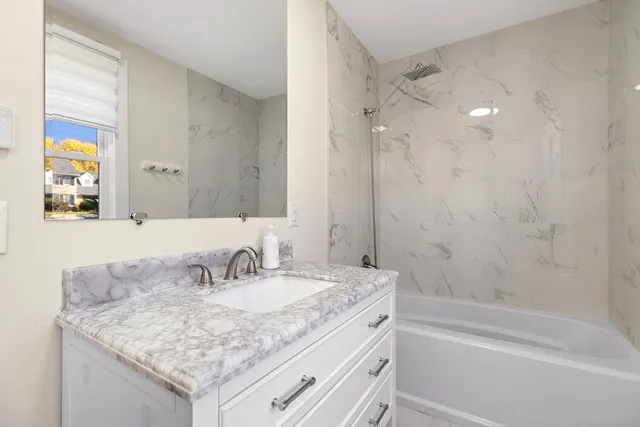 a living room with baby crib furniture and a window