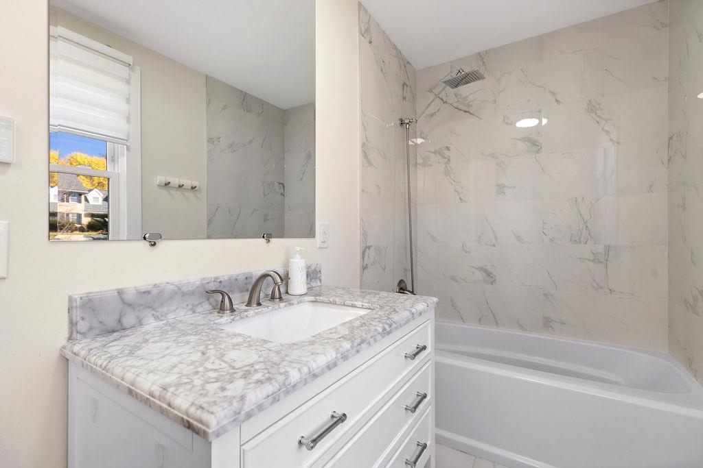 1368 Bluewater Road Harrisonburg, VA 22801 - Photo 28 of 52 a bathroom with a granite countertop sink a mirror a vanity and a bathtub