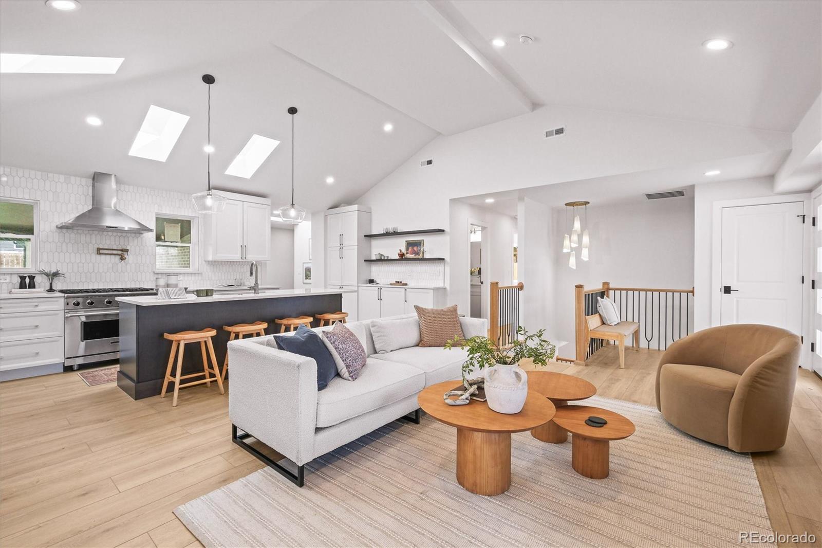 a living room with furniture and kitchen view