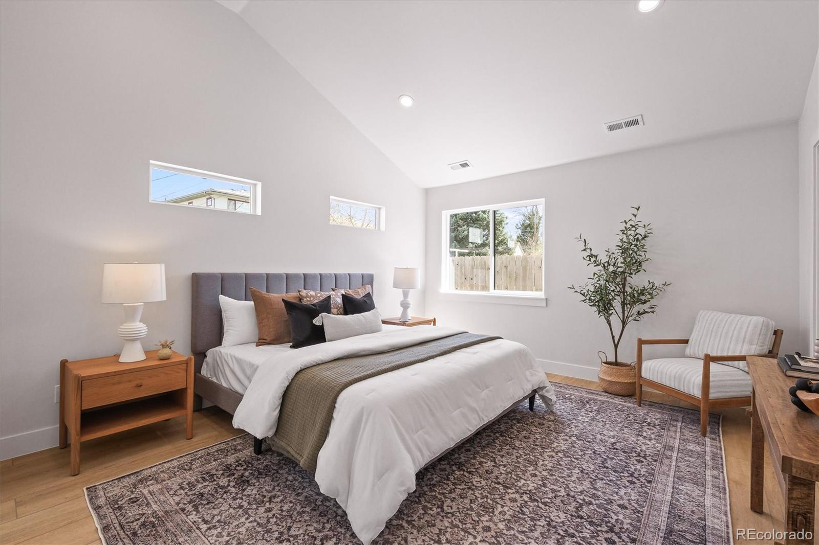 2950 South Adams Street Denver, CO 80210 - Photo 14 of 42 a bedroom with bed and a potted plant