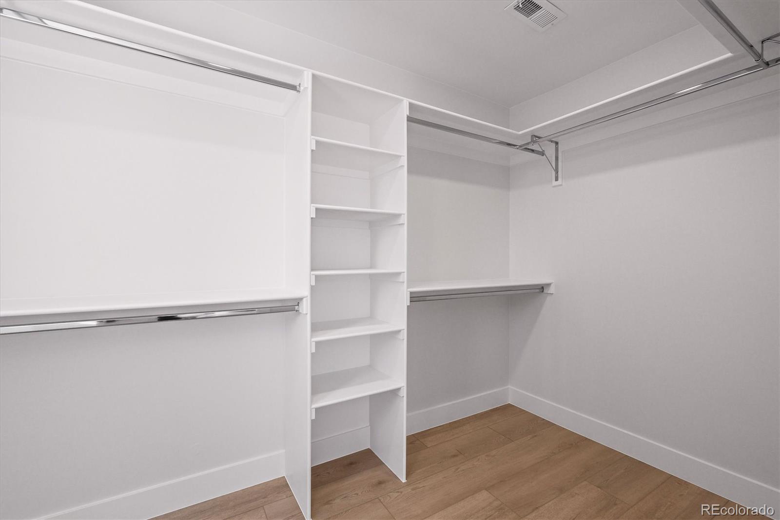 2950 South Adams Street Denver, CO 80210 - Photo 15 of 42 a view of walk in closet with empty racks