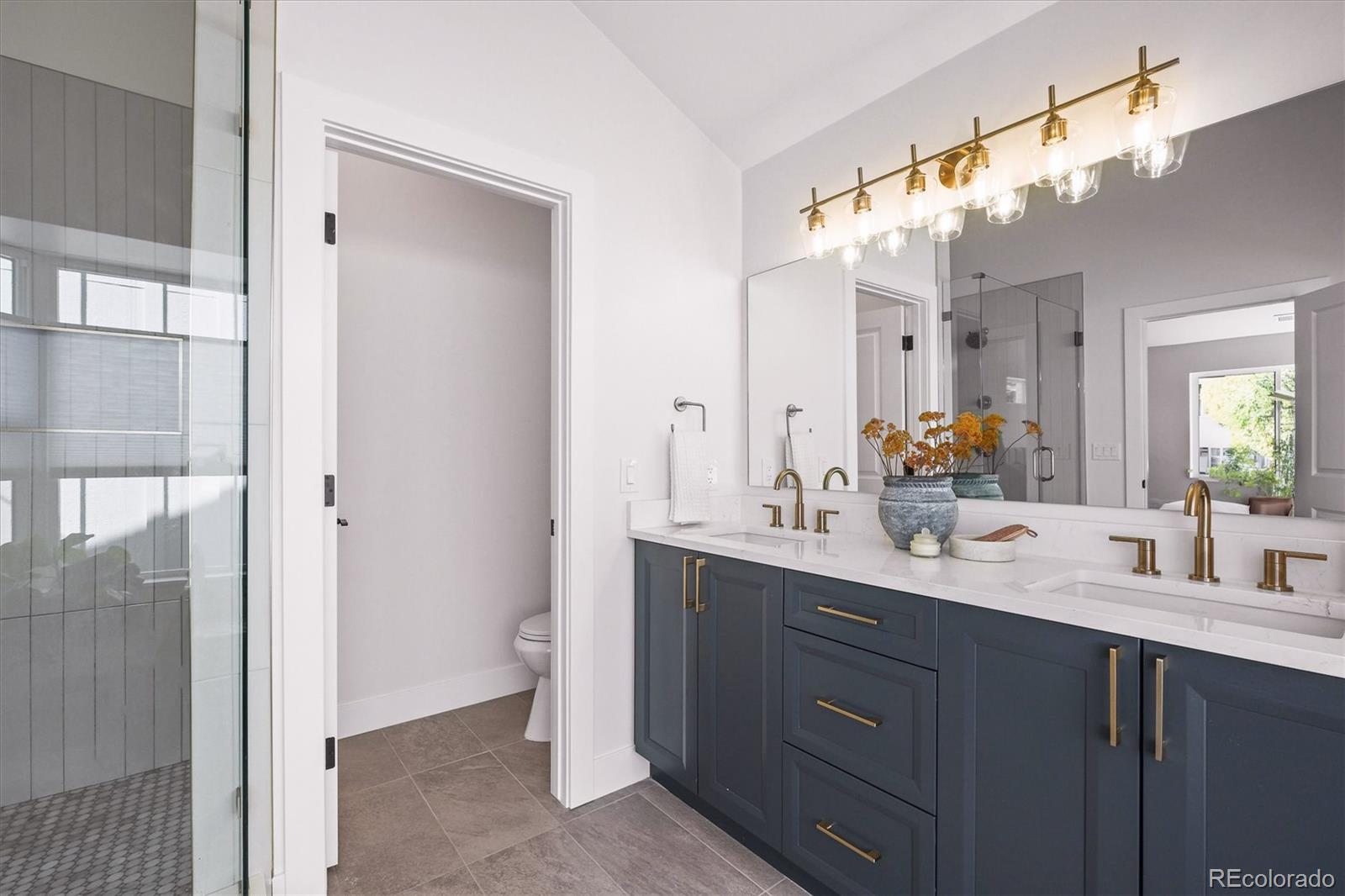 2950 South Adams Street Denver, CO 80210 - Photo 18 of 42 a bathroom with a sink vanity granite and a mirror