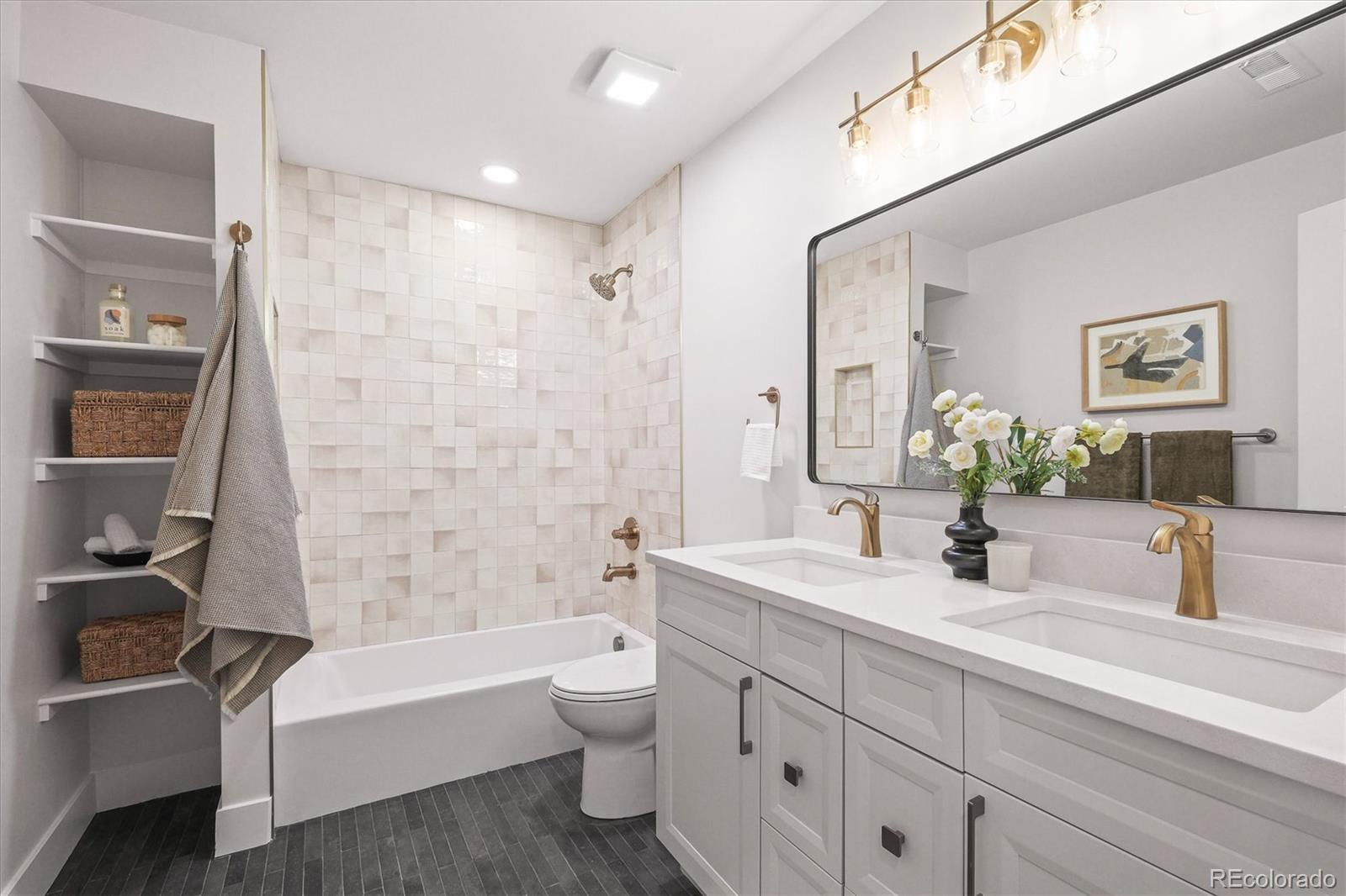 2950 South Adams Street Denver, CO 80210 - Photo 21 of 42 a bathroom with a bathtub shower sink vanity mirror and toilet