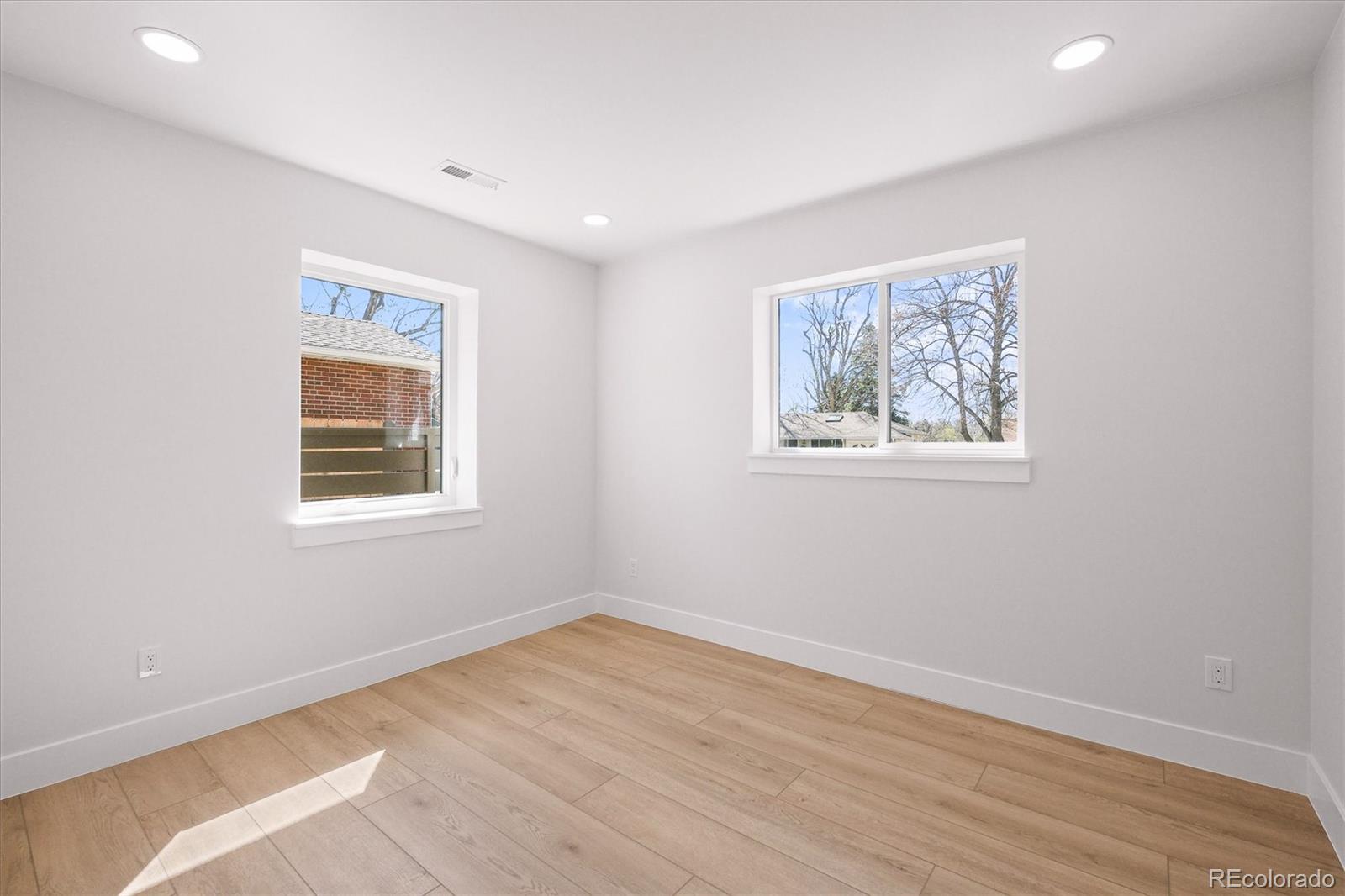 2950 South Adams Street Denver, CO 80210 - Photo 22 of 42 a view of empty room with wooden floor and fan