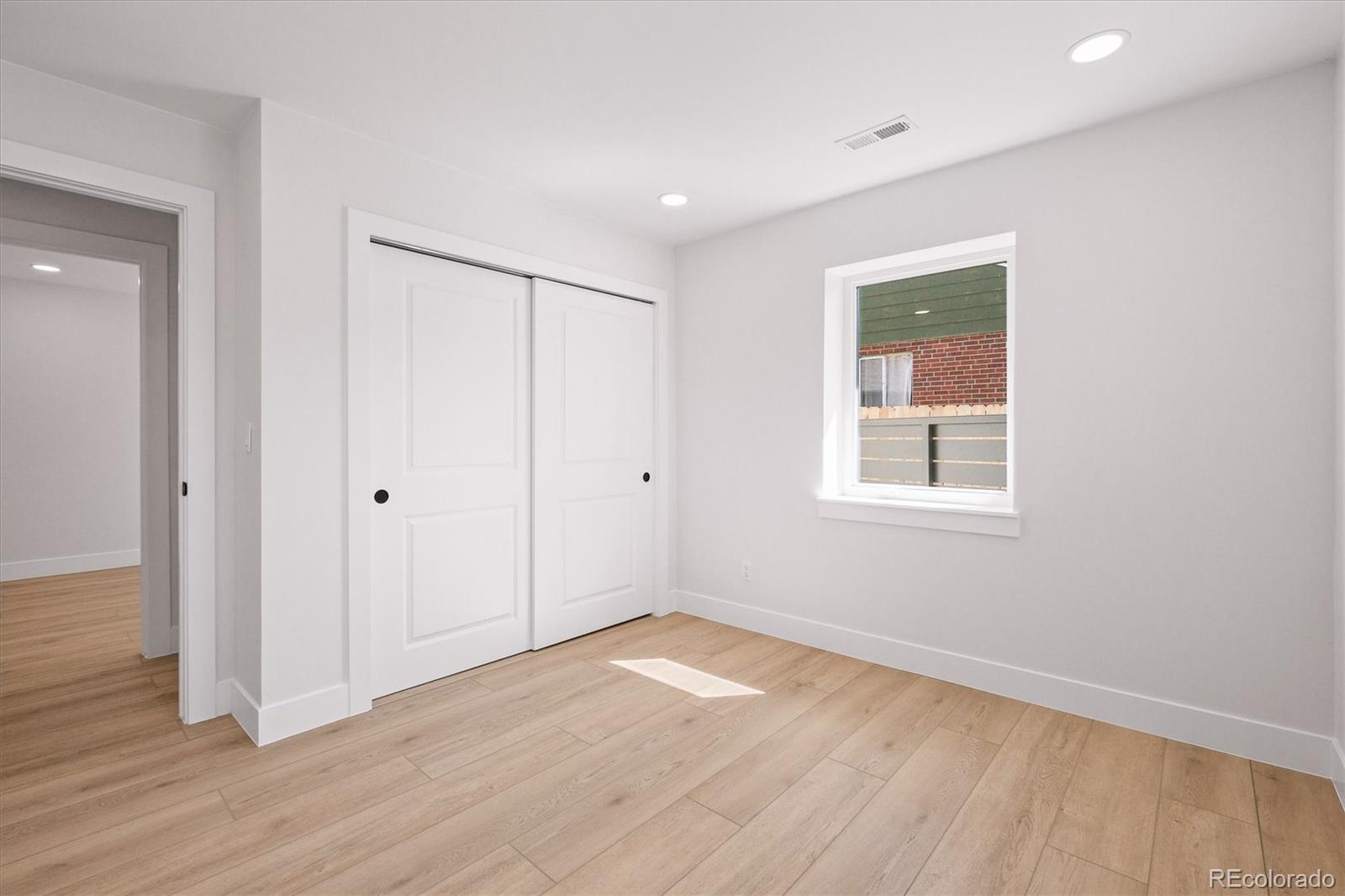 2950 South Adams Street Denver, CO 80210 - Photo 23 of 42 a view of a room with wooden floor and window