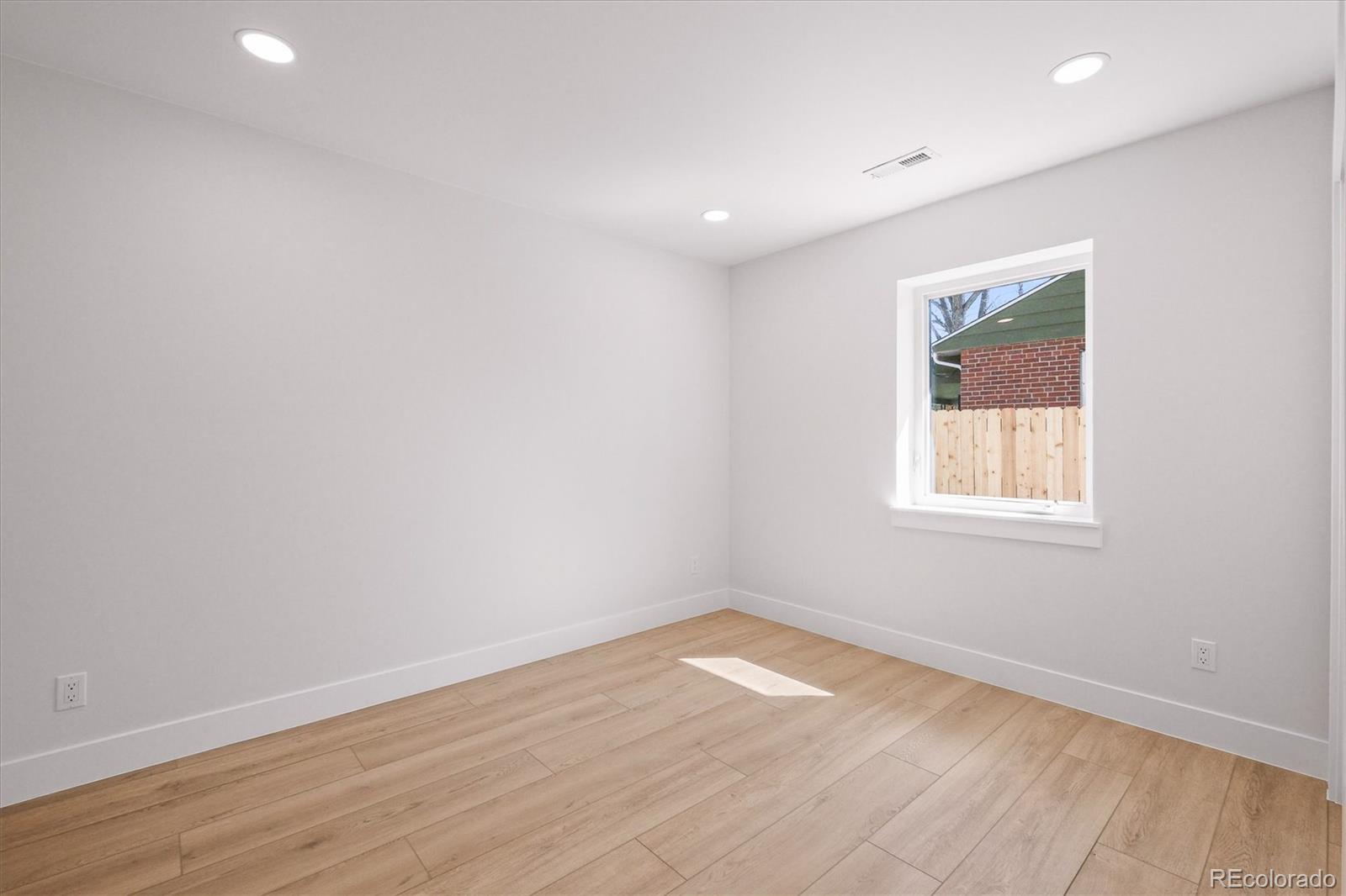 2950 South Adams Street Denver, CO 80210 - Photo 24 of 42 a view of empty room with wooden floor and fan