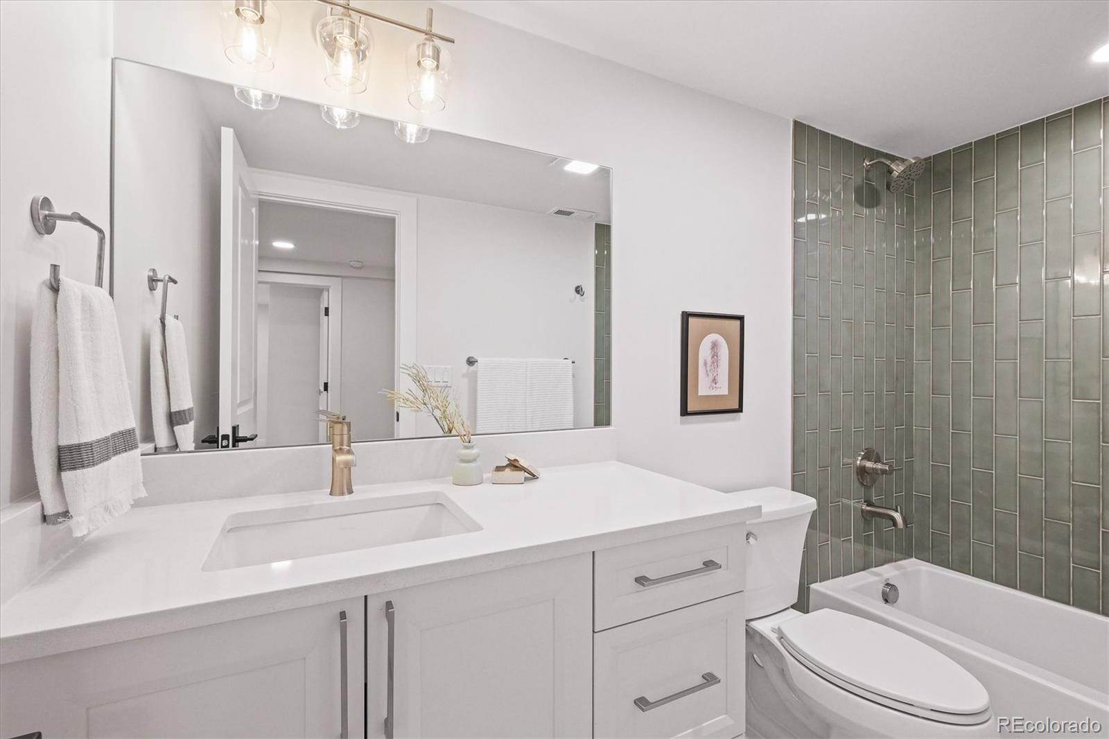 2950 South Adams Street Denver, CO 80210 - Photo 29 of 42 a bathroom with a double vanity sink mirror double and toilet