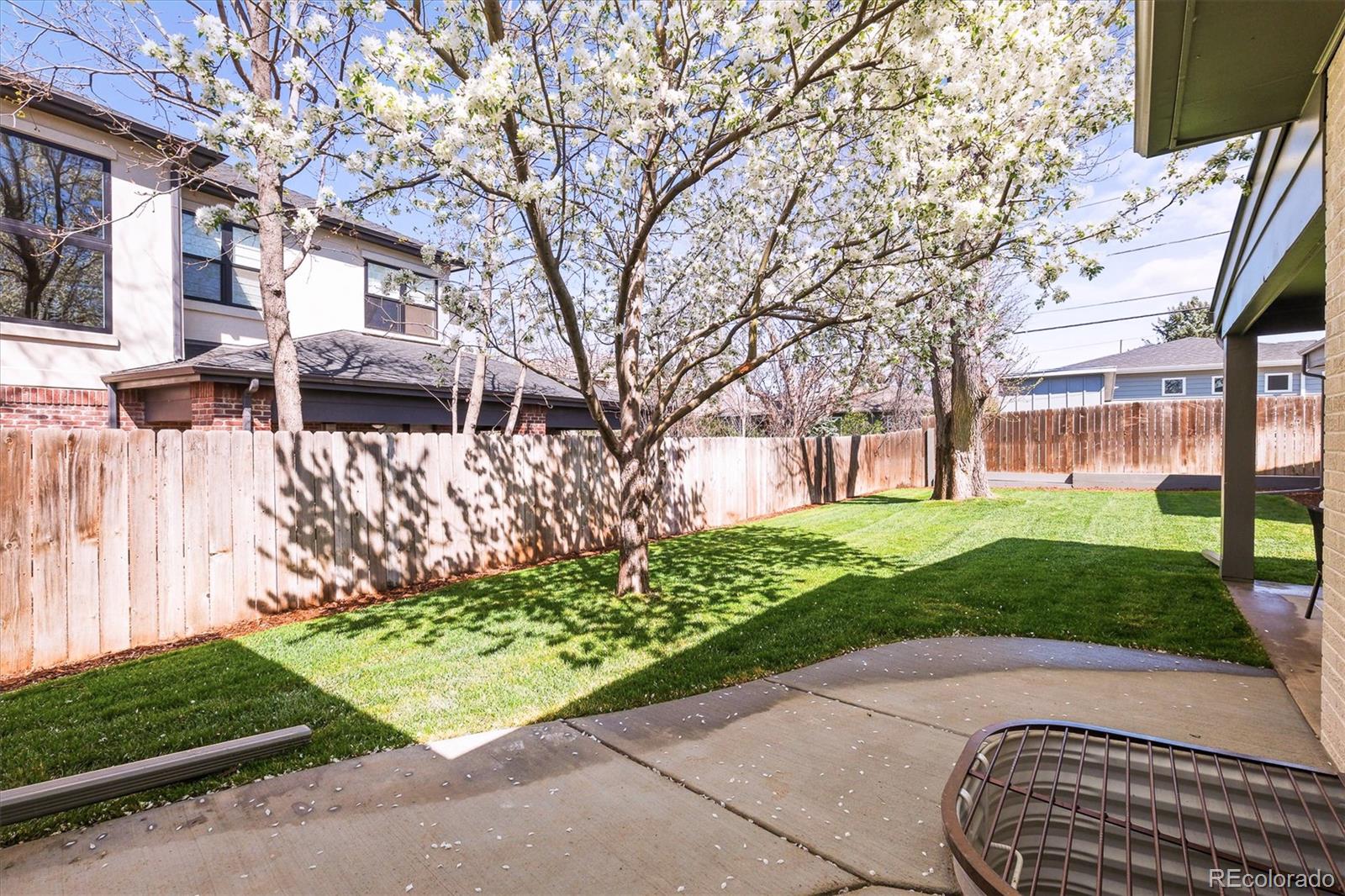 2950 South Adams Street Denver, CO 80210 - Photo 34 of 42 a front view of a house with a yard and table and chairs