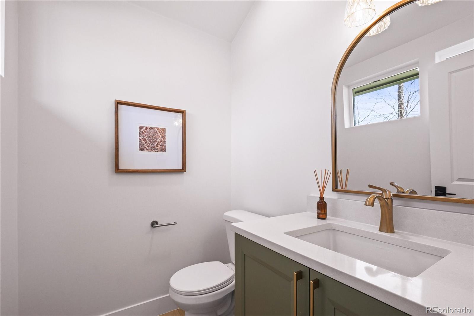 2950 South Adams Street Denver, CO 80210 - Photo 6 of 42 a bathroom with a granite countertop toilet sink and mirror