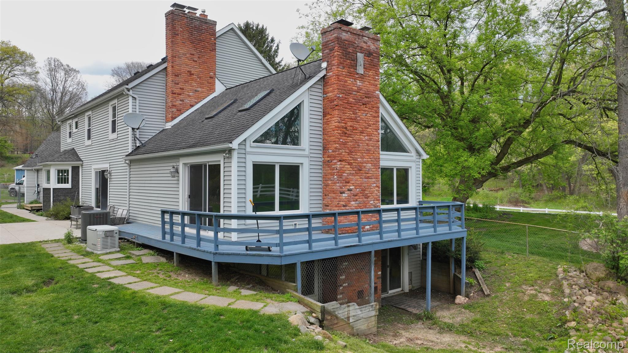 10300 Clark Road Davisburg, MI 48350 - Photo 4 of 39 Rear view of house featuring a wooden deck, a chimney, and a shingled roof