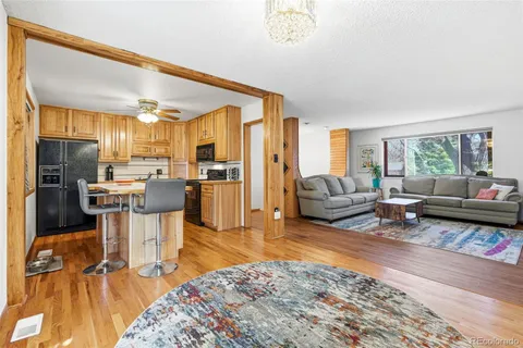 a kitchen with a table chairs refrigerator and microwave