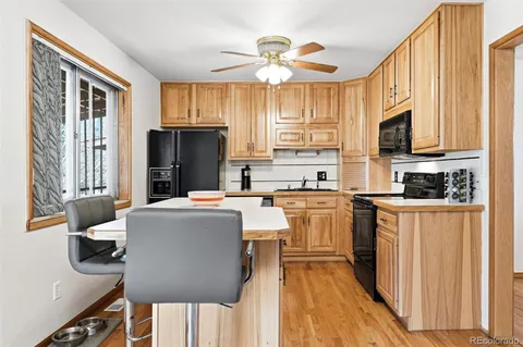 a kitchen with stainless steel appliances granite countertop a stove a sink dishwasher and a refrigerator