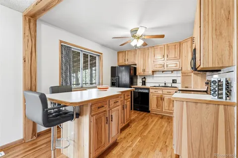 a kitchen with stainless steel appliances a stove a sink island and a refrigerator