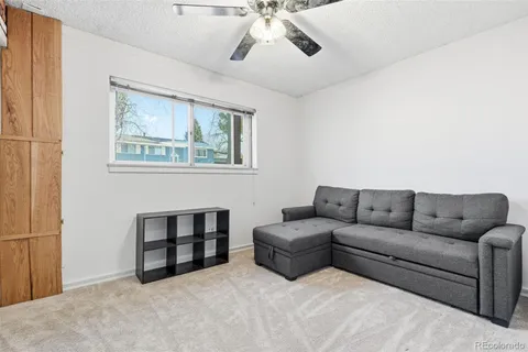 a view of workspace with furniture and a ceiling fan