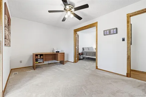 a view of a livingroom with a ceiling fan hardwood floor and a ceiling fan