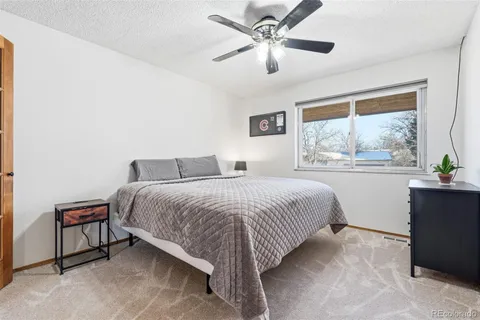a bedroom with a large bed and a window