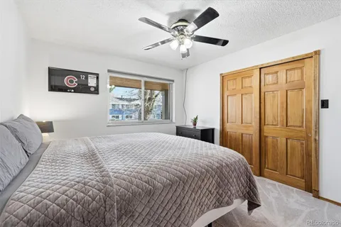 a spacious bedroom with a bed and a chandelier