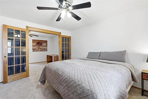 a bathroom with a granite countertop sink a toilet a mirror and shower