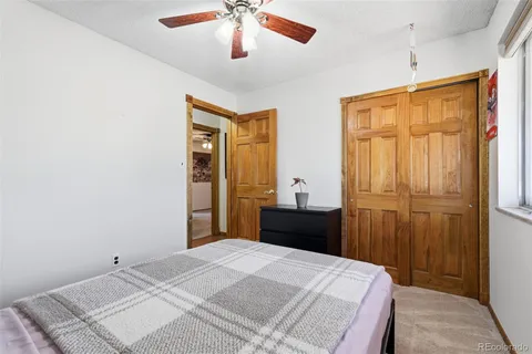 a spacious bedroom with a bed and a painting