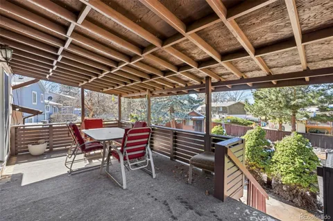 a view of balcony with wooden floor and fence