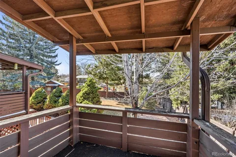 a view of a yard with plants and trees