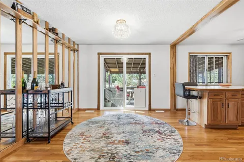 a living room with furniture flat screen tv and a large window