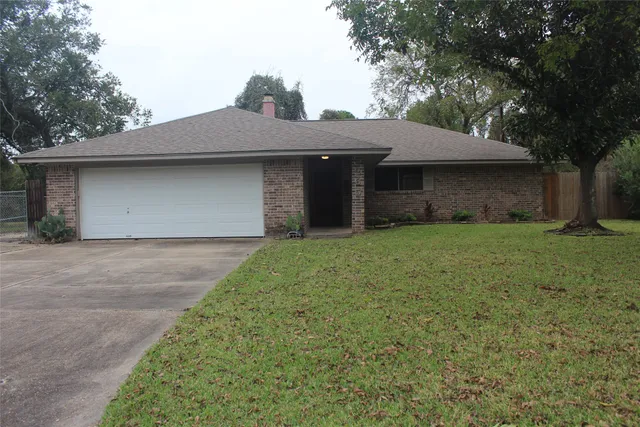 a front view of house with yard and trees