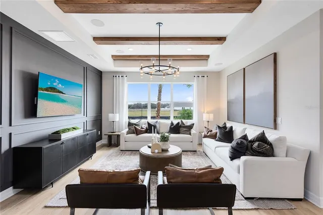 a living room with furniture a fireplace and a chandelier
