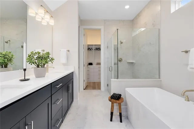 a en suite spacious bathroom with a shower a sink and a mirror