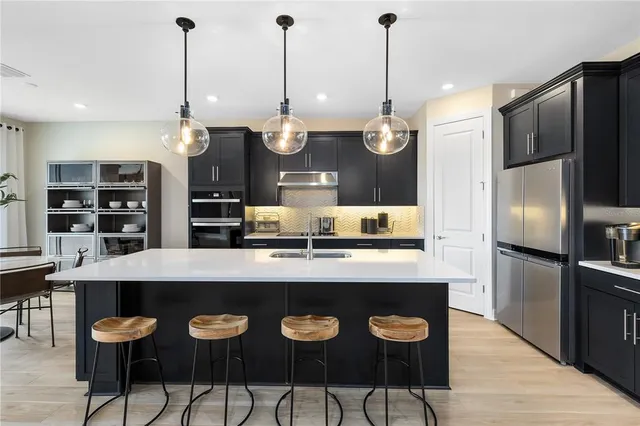 a kitchen with a sink a counter top space and stainless steel appliances
